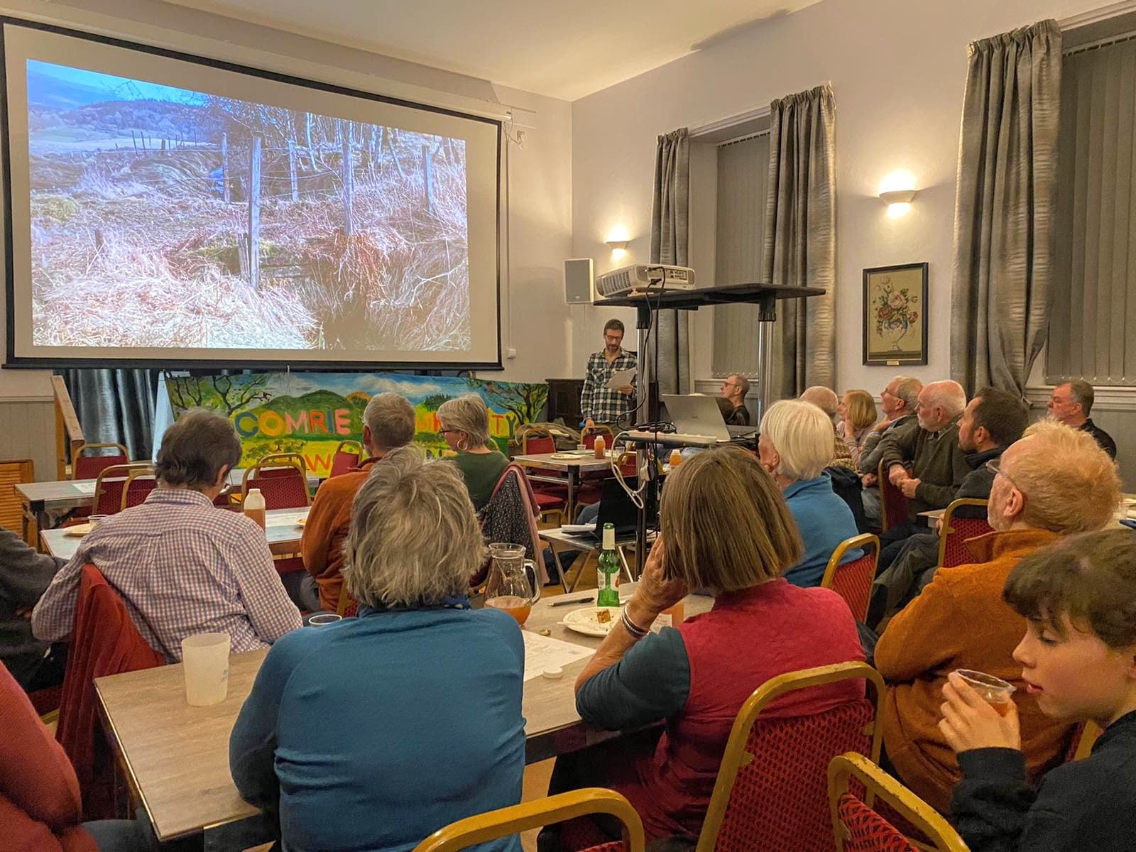 Community meeting at Cultybraggan Camp with residents gathered for an evening talk